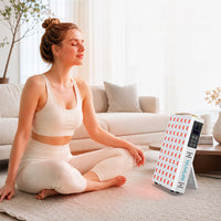 Woman meditating beside the YA60-2W7 panel during an at-home red and near-infrared light therapy session