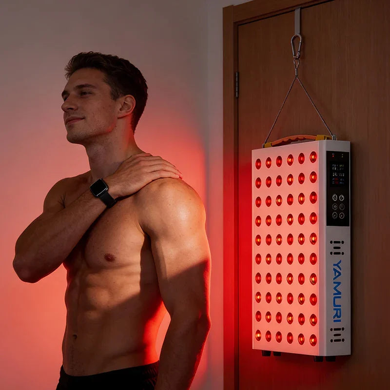 Man using red light therapy panel for muscle recovery and skin health at home