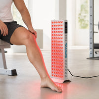 Man positioning his knee beside the illuminated YA120-2W7 half-body panel in a home gym