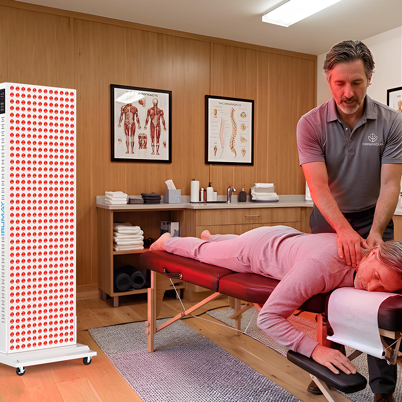 Red light therapy panel in a wellness clinic, therapist giving massage to client on table