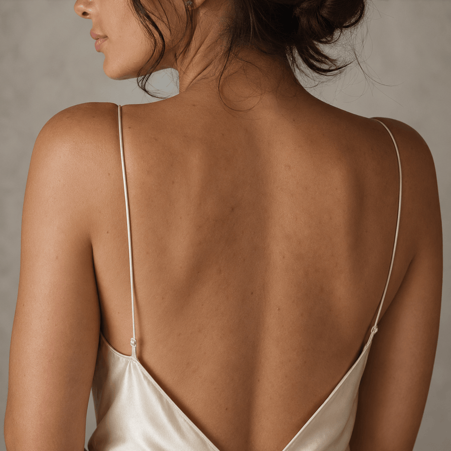 Before image showing uneven-looking back skin tone before a red light therapy body routine